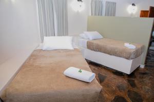 a room with two beds with towels on a ottoman at Kruger Whispering Waters in Hazyview +20 photos