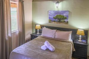 En eller flere senge i et værelse på Aan De Vliet Holiday Resort