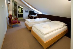 Posteľ alebo postele v izbe v ubytovaní Hotel Purkmistr