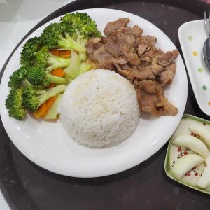 um prato branco de alimentos com arroz e brócolos em BA CON ECH Home and Stay- No 28 lane 259 Nguyen Duc Canh em Hai Phong
