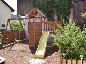 a playground with a slide in a backyard at Landgasthof Zum Jossatal in Bad Soden-Salmünster