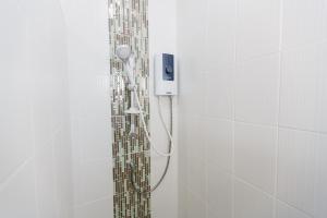 a shower with a shower head in a bathroom at YaYa B By Briza Group in Chalong