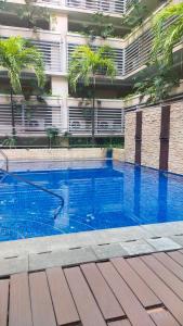 a swimming pool in front of a building at 150 Newport Boulevard Near NAIA Terminal 3 in Manila