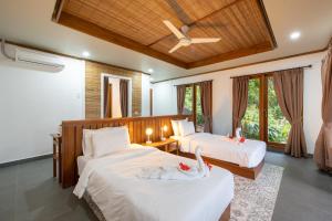 Ένα ή περισσότερα κρεβάτια σε δωμάτιο στο Murex Bangka Dive Resort
