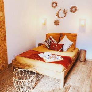 a bedroom with a bed with pillows on it at Hôtes de Maïa Chambre d'hôtes in Moret-sur-Loing