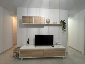 a flat screen tv sitting on top of a cabinet at Fuengirola Center in Fuengirola