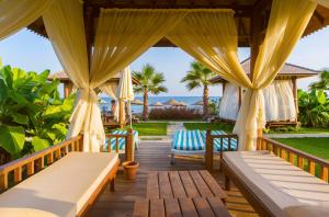 una terraza de madera con sillas y sombrillas en Eftalia Aqua Resort, en Konaklı