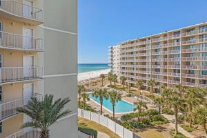 a view of the beach from the balcony of a resort at Tradewinds Unit 406 in Orange Beach