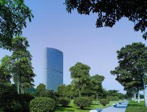 a tall building in the middle of a park at Shangri-la Guangzhou -Traffic free, 3 minutes walk to Canton Fair & Overseas Buyers Registration Service in Guangzhou