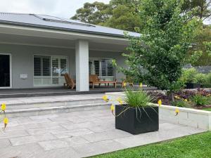 a house with a patio and a tree in front of it at The Bunkhouse in Exeter