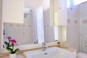 a bathroom with a sink and a mirror and a tub at a casa di Chiara bed and breakfast in Capaccio-Paestum