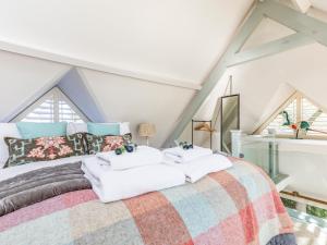 a bedroom with a large bed in a attic at Pass the Keys Peaceful and beautiful 1 bedroom barn conversion in Chichester