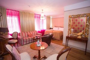 a living room with a couch and a bed at Townhouse Boutique Hotel in Zürich