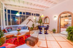 a living room with a couch and a table at Dar Cherazade & spa in Essaouira
