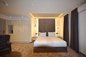 a hotel room with a bed and a couch at Hotel Boutique Bristol in Sarajevo