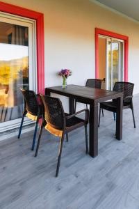 a dining room table with chairs and a table at Airport Guest House in Dalaman