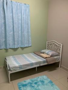 a small bed in a room with a window at LA 1 Homestay Putrajaya Dwiputra in Putrajaya