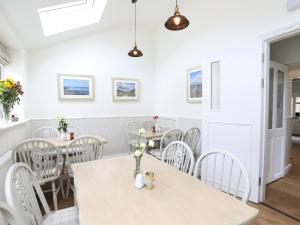 a dining room with white tables and chairs at The Willow Restaurant B&B in Pateley Bridge +11 photos