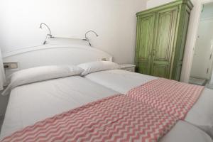 A bed or beds in a room at Real View Beach Front
