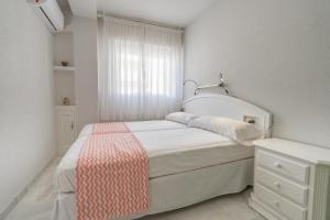 A bed or beds in a room at Real View Beach Front