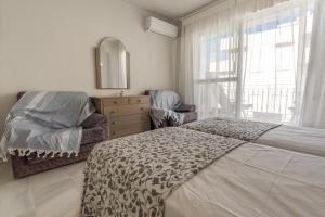A bed or beds in a room at Real View Beach Front