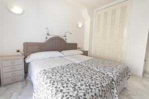 A bed or beds in a room at Real View Beach Front