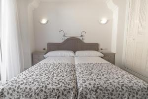 A bed or beds in a room at Real View Beach Front