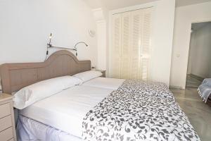 A bed or beds in a room at Real View Beach Front