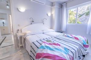 A bed or beds in a room at Real View Beach Front