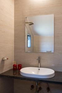 a bathroom sink with a mirror on a counter at West Valley Villa 3BHK B in Mahabaleshwar