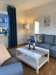 a living room with a couch and a coffee table at Haus Pirola Esens in Esens