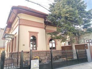 a house with a fence in front of it at Erbario House in Bucharest