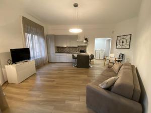 uma sala de estar com um sofá e uma cozinha em Genoa Lux Apartments with parking em Gênova