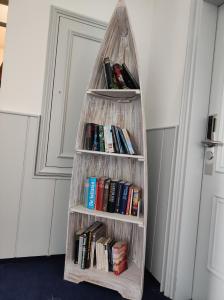 a bookshelf filled with books and bookshelves at Nordsee Hotel Borkum in Borkum