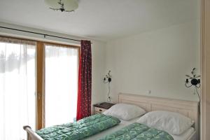 a bedroom with two beds and a large window at Chalet in Hochkrimml in Krimml