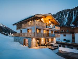 a house in the snow in the mountains at Avero Lodge by MEIN SAMNAUN - MOUNTAIN HOMES in Samnaun