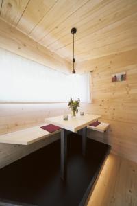 Cette chambre en bois dispose d'une table et d'une fenêtre. dans l'établissement Gästehaus berge, à Aschau im Chiemgau