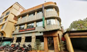 a building with motorcycles parked in front of it at Treebo Apollo in Guwahati