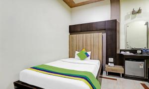 a bedroom with a bed and a bathroom with a sink at Treebo Apollo in Guwahati