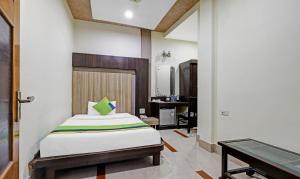 a bedroom with a bed and a pool table at Treebo Apollo in Guwahati