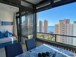 a room with a table and chairs and a large window at Gerona Dream in Benidorm