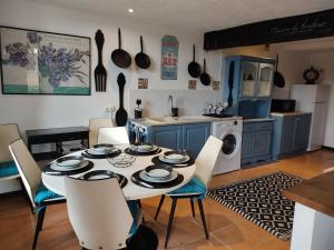 a kitchen with a table and chairs in a kitchen at Les quatre vents in Ars