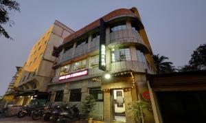 a building with motorcycles parked in front of it at Treebo Apollo in Guwahati