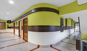 a hallway of a building with green and white at Treebo Apollo in Guwahati