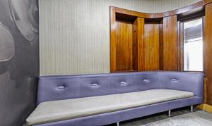 a blue bench in a room with a window at Treebo Apollo in Guwahati