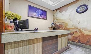 a lobby with a reception desk with a painting of an elephant at Treebo Apollo in Guwahati