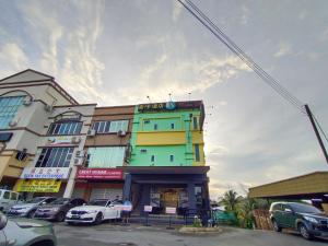 a colorful building with cars parked in front of it at Super OYO 90478 Marina World in Kuching