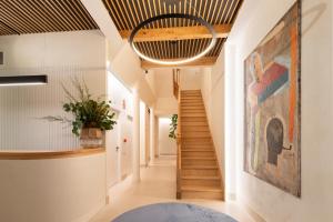 a hallway with a staircase and a painting on the wall at NORO Plaza in A Coruña