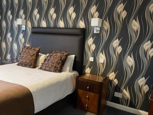 a bedroom with a bed and a lamp at Castlecary House Hotel in Cumbernauld