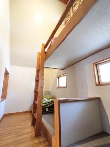 a loft bed in a room with a bunk bed at Asuka's House 1 - Vacation STAY 30115v in Hokuto